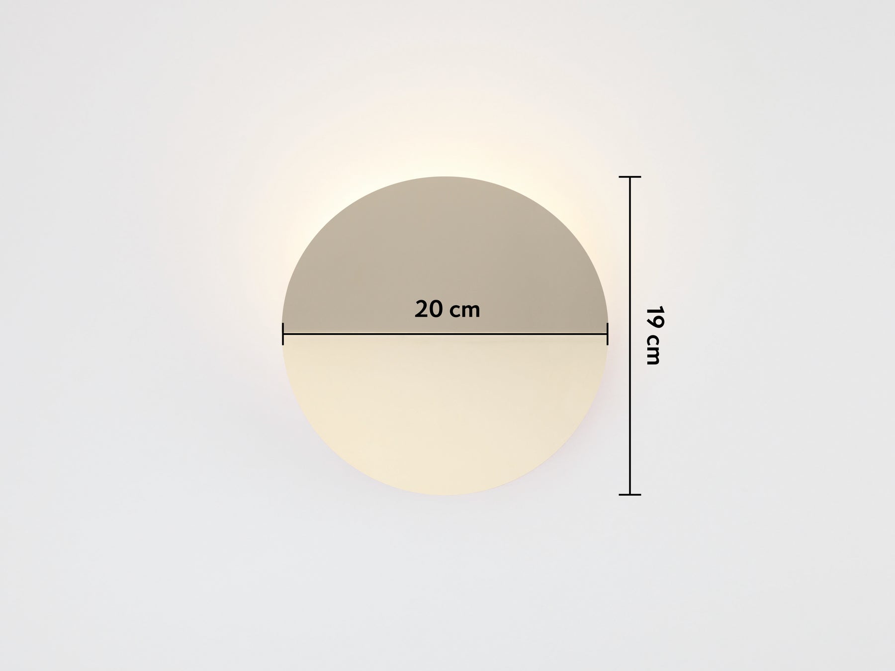A brass circular wall light that sits flush to the wall, with a subtle fold and integrated LED bulbs with dimensions overlay (20x19cm)