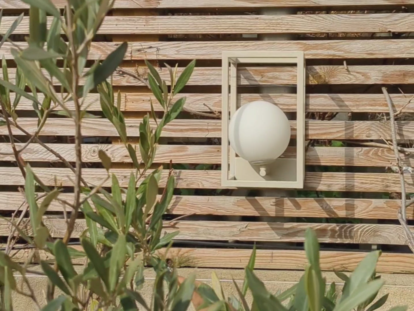 A traditional lantern style outdoor light, with deconstructed walls and a glass globe that sits within. 