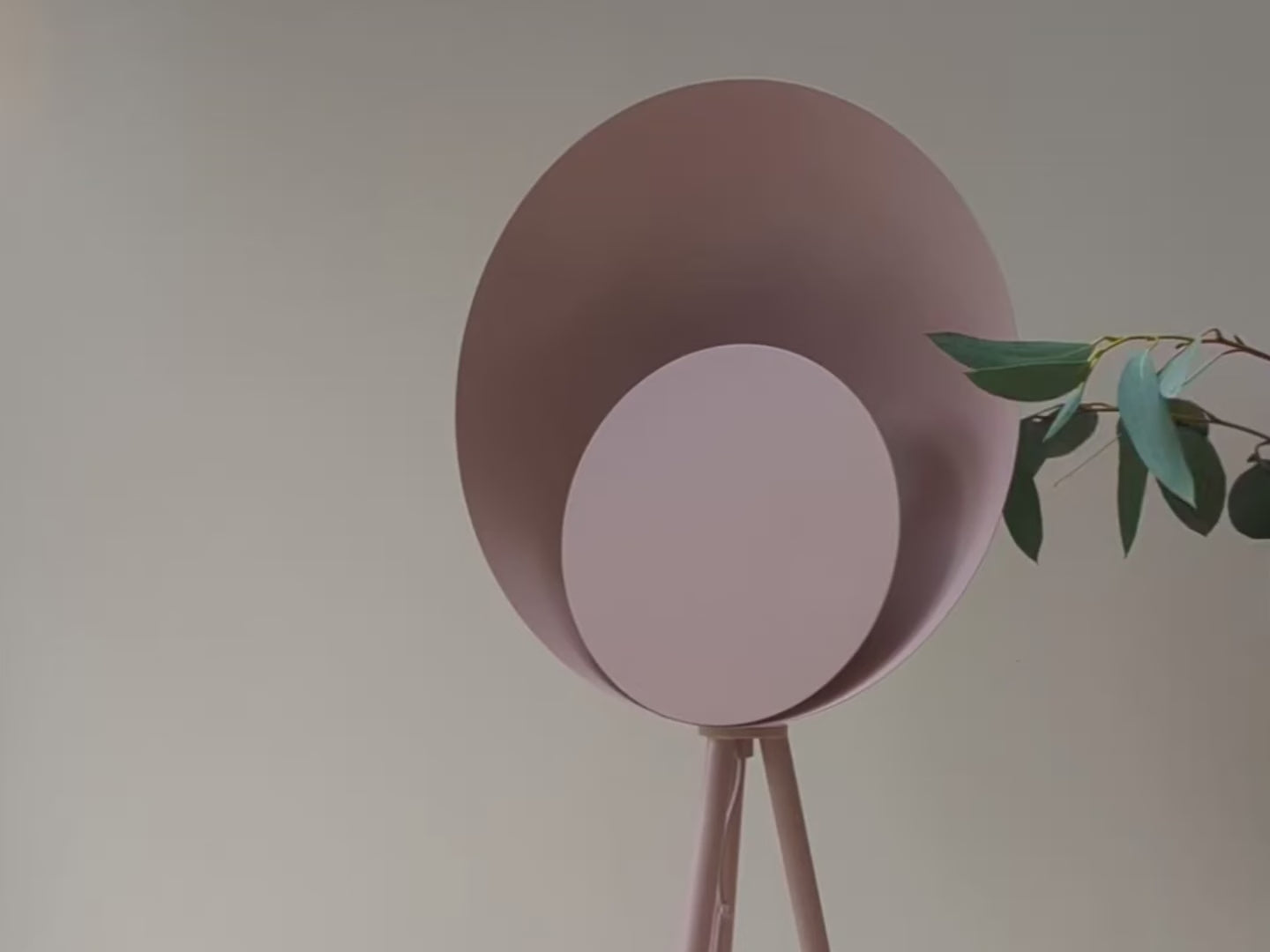 A pink tripod base suspends an oversized pink dome head with a diffused, integrated LED light. Light off and then on.
