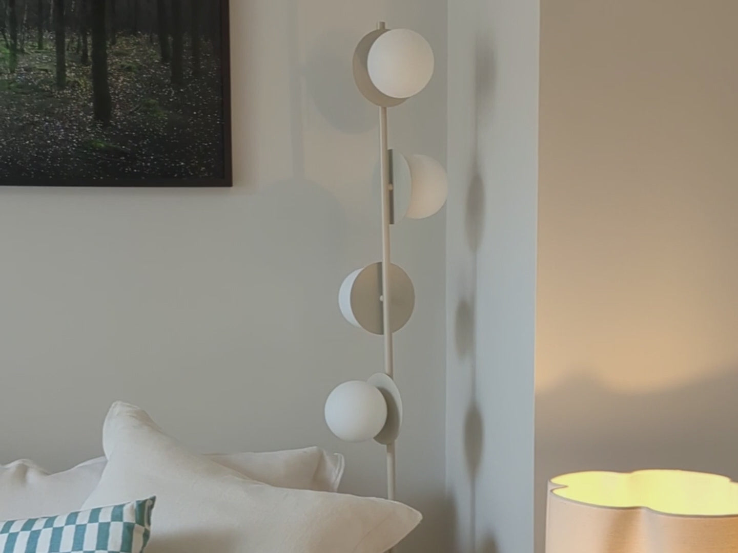 Sand opal disk floor lamp positioned in a living room.