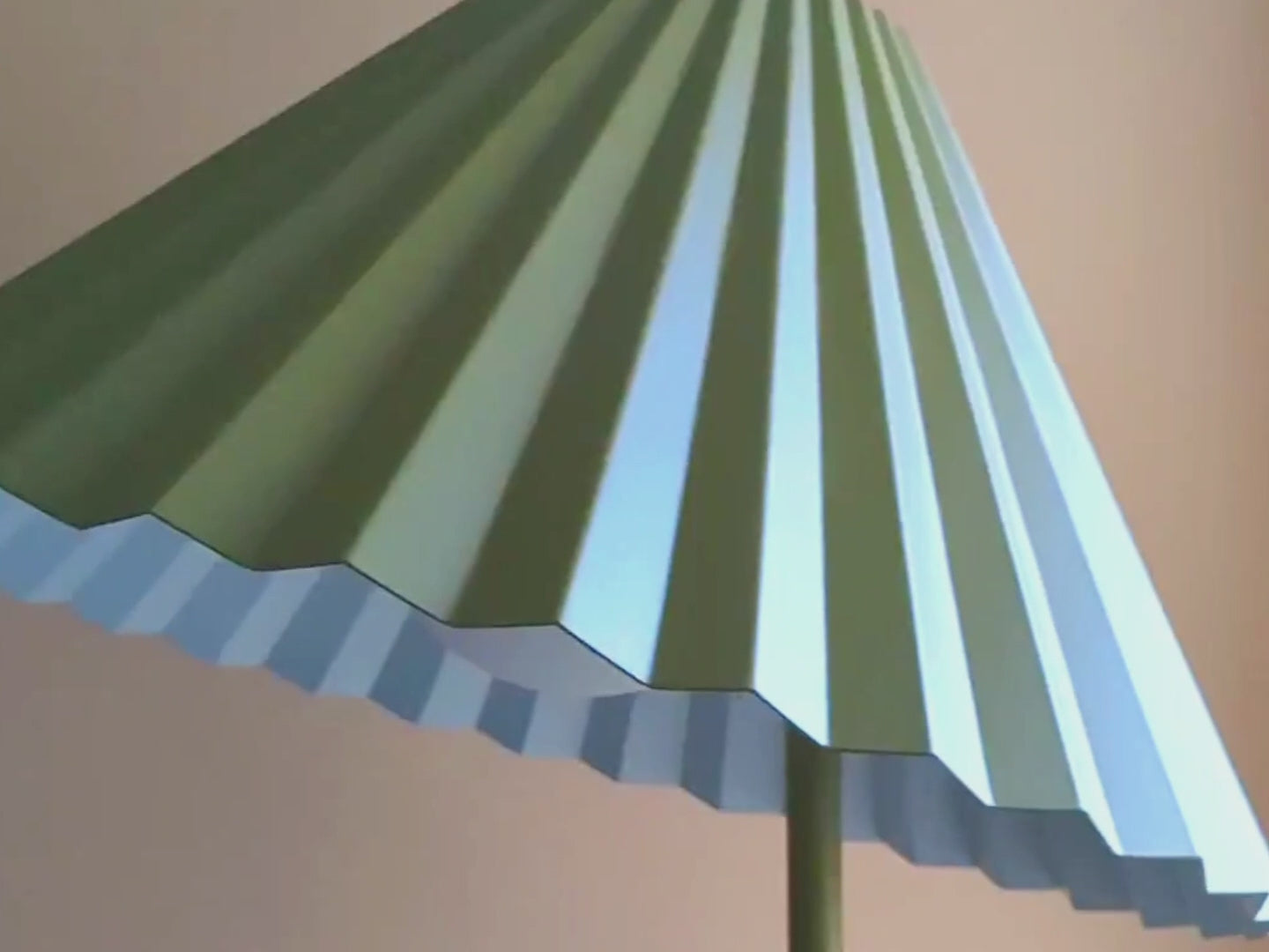 A floor lamp with a fluted, pleated metal shade that can be tilted and adjusted. It is painted moss green, with a contrasting pale blue colour inside the shade.