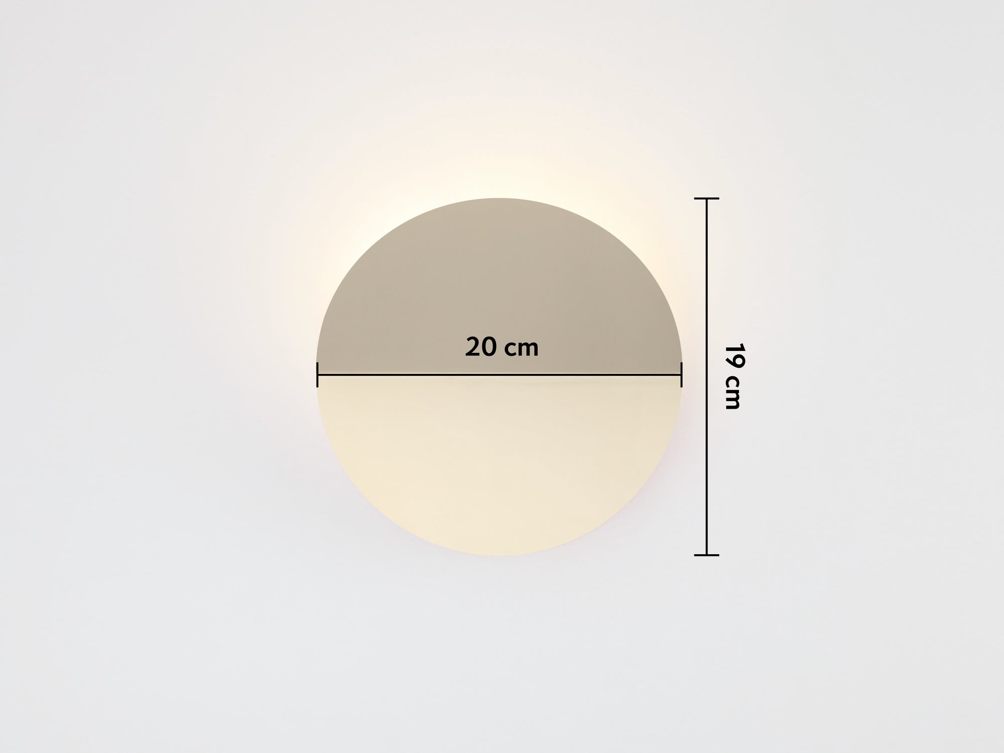 A brass circular wall light that sits flush to the wall, with a subtle fold and integrated LED bulbs with dimensions overlay (20x19cm)